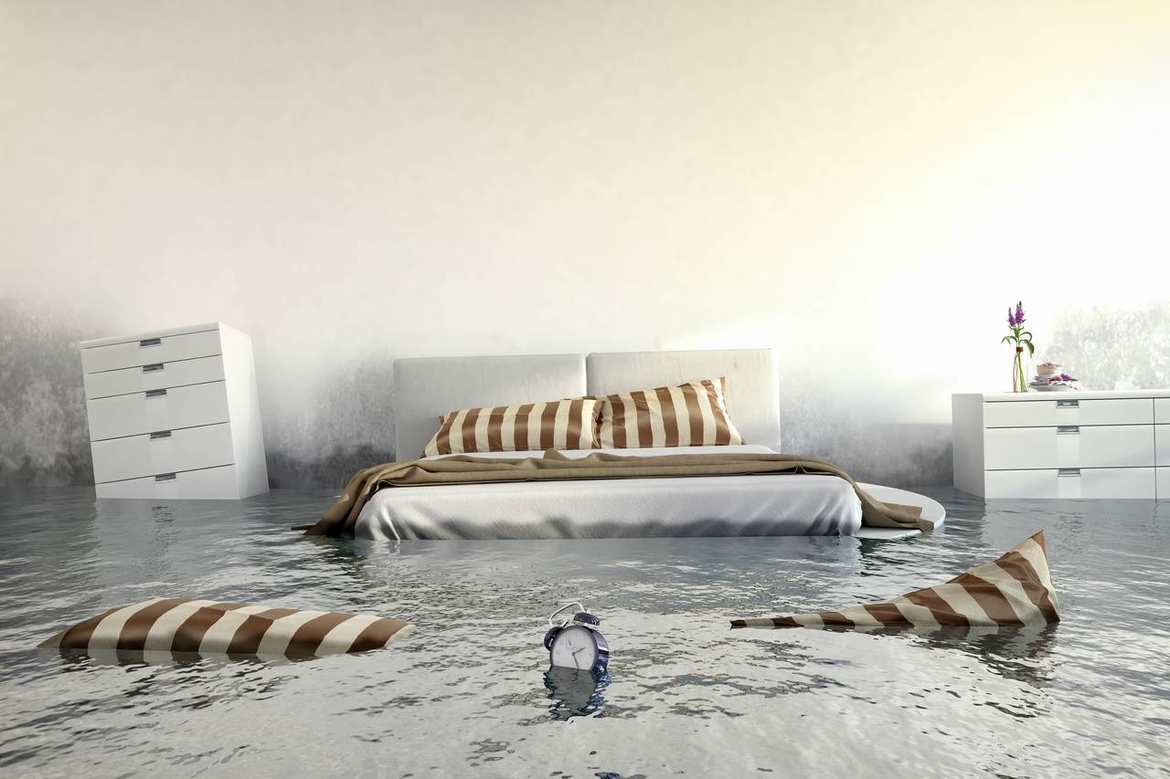 A bedroom is flooded and furniture is floating around